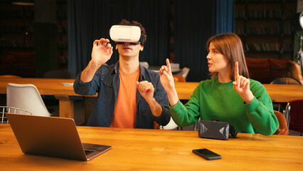 Man exploring virtual reality with woman assistant, online technology concept