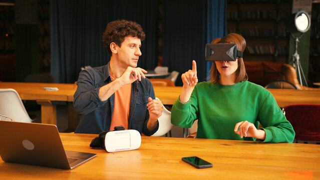 Colleagues collaborating on virtual reality project in modern office - Powered by Adobe