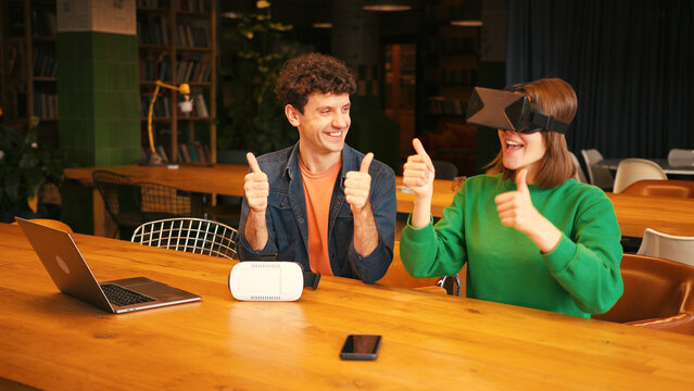 Colleagues collaborating on virtual reality project in modern office