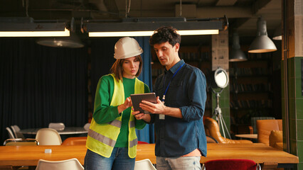 Project manager and female engineer shaking hands in modern office