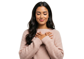 Young hispanic woman, light pink knit sweater, dark wavy hair, smiling sincerely with closed eyes, hands pressed to heart on a transparent background, soft beauty light. Concept of deep appreciation