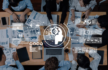 A group of business professionals collaborates around a table, analyzing data and generating AI insights through charts and reports in a modern office setup. Trope