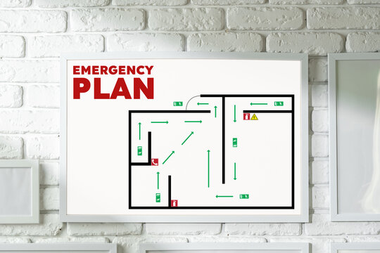 Emergency plan layout displayed on a wall with clear exit routes and safety instructions