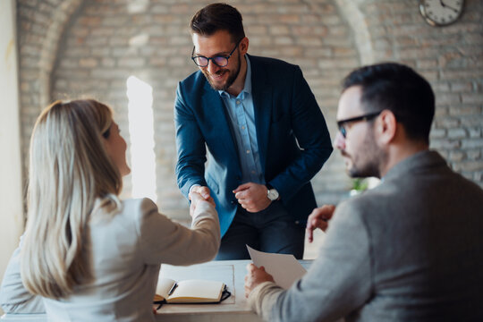 Business people shaking hands in the office. - Powered by Adobe