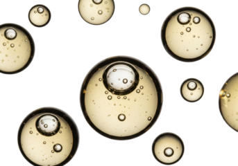 Golden amber viscous oil bubbles and droplets with trapped air, macro on transparent background, clean minimalist concept for cosmetic product