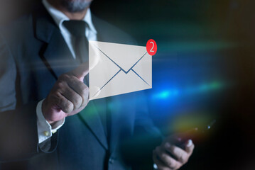 Businessman touching new message on virtual screen, New email notification concept for business e-mail communication and digital marketing. Inbox receiving electronic message alert.