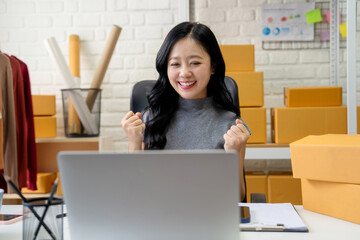 Asian SME businessman using laptop to check customer orders online. Work from home concept.
