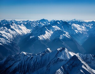 high angle view of snow capped mountain ranges appearing dark blue and white