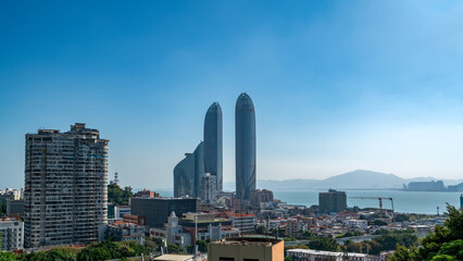 Modern cityscape with tall skyscrapers under clear blue sky