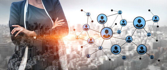 A confident businesswoman stands against an urban backdrop, symbolizing teamwork and networking opportunities in a modern corporate environment. Tessel