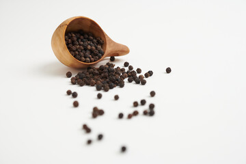 Organic Black Pepper Seeds in Wooden Scoop