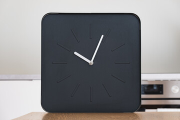Minimalist black square clock showing the time