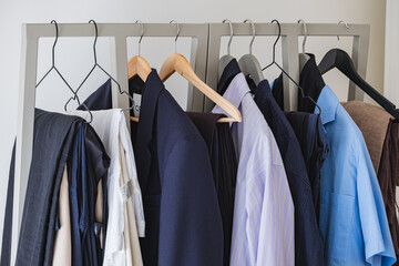 Minimalist clothing rack with assorted unisex shirts and blazers