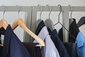 Minimalist clothing rack with assorted unisex shirts and blazers