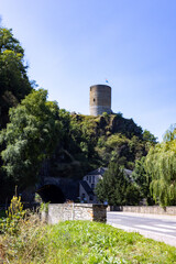 Fototapeta premium Esch-sur-Sure, Wiltz, Grand-Duche de Luxembourg, September 07, 2025, Scenic historic vantage point, Old tower over flowing river, Traditional lookout with serene water and lush trees