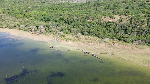 Traditional Thonga (Tsonga) Fish traps on the edge of Kosi Lake at Kosi Bay, with a camera slowly circling to show the fish traps and the lakeshore.  4K Aerial Video