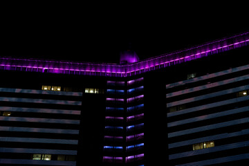 Fototapeta premium Moscow High-Rise with Purple and Blue LED Facade at Night