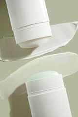 Cosmetic two products solid deo-sticks with swatch sample stroke isolated on green