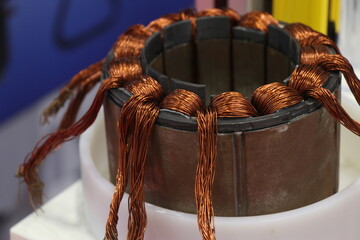 Electrical motor stator coil winded with copper wires close up view. Parts of electric motor