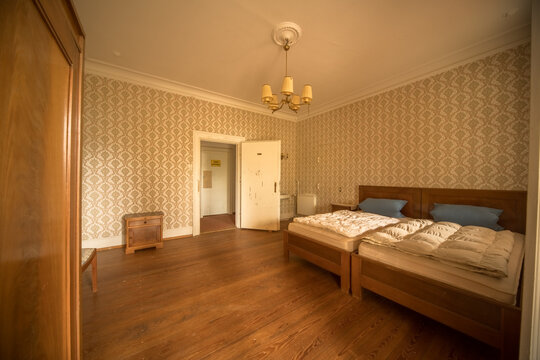 Vintage Bedroom with Twin Beds, Damask Wallpaper and Chandelier