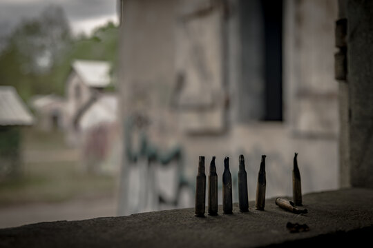 Spent bullet casings on windowsill of a derelict military building