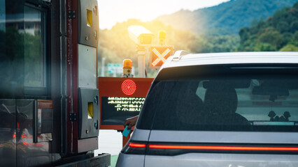 Car at toll booth with mountainous background