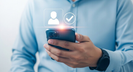 Man holds smartphone with profile verification checkmark showcasing secure access and identity confirmation on a mobile device emphasizing digital security and user authentication process