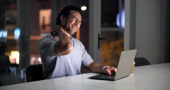 Night, tired man and laptop in office with neck pain from bad posture, marketing workload or fatigue. Late, exhausted person or muscle tension with computer, advertising project or deadline pressure.