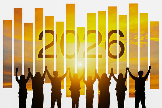 Silhouette teamwork raising hands toward &ldquo;2026,&rdquo; symbolizing new goals for the new year.