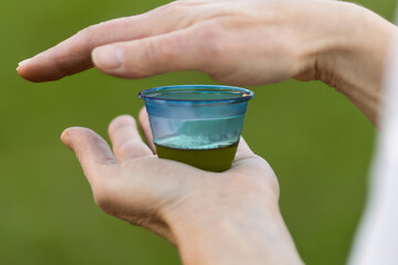Professional tasting of extra virgin olive oil in a blue cup. Sensory analysis of food quality.