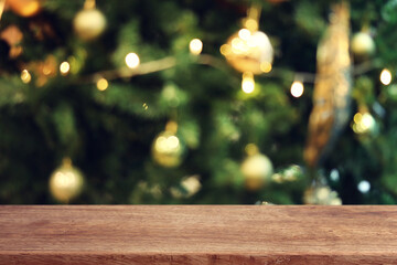Background of blurred Christmas tree and empty table for mockup
