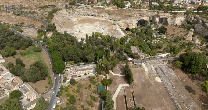Aerial view of the Neapolis Archaeological Park, located in Syracuse, Sicily, Italy. In background are the ruins of the Greek theater, the Ear of Dionysius, the Ropemakers' and the Saltpetre Cave.