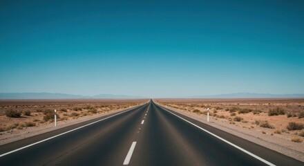 Fototapeta premium Empty highway stretches into a vast, arid landscape under a vibrant blue sky