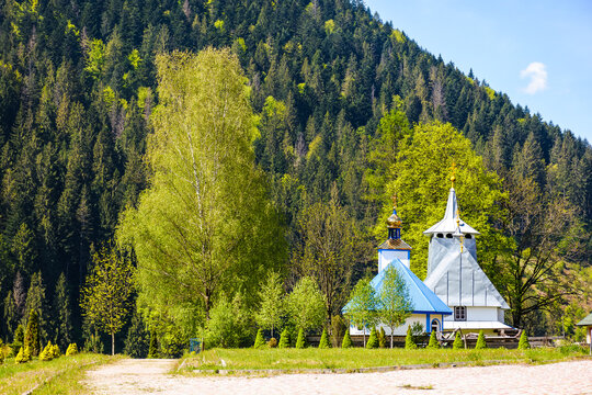soimy, transcarpathia, ukraine - may 12 2019: orthodox wooden church of saint basil the great. old building with steeple on the hill under blue sky. mountainous rural scene on a sunny day in spring