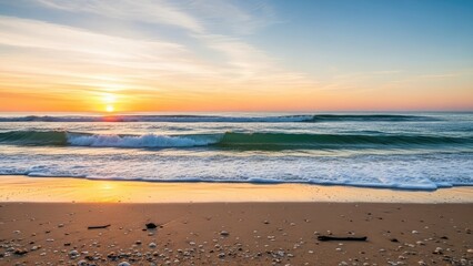 Beautiful sunset over the ocean with gentle waves breaking on a sandy beach