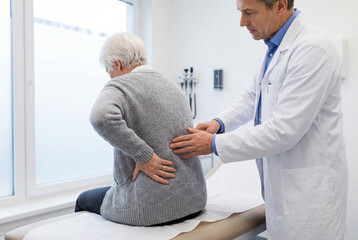 Elderly woman with back pain examined by doctor in medical clinic.