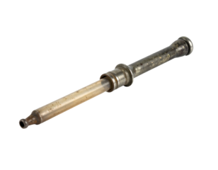 Vintage metal syringe with glass barrel medical instrument showing patina and wear on isolated background
