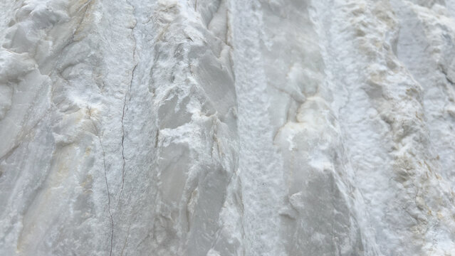 Close-up view of white marble texture with natural patterns and rough surface details