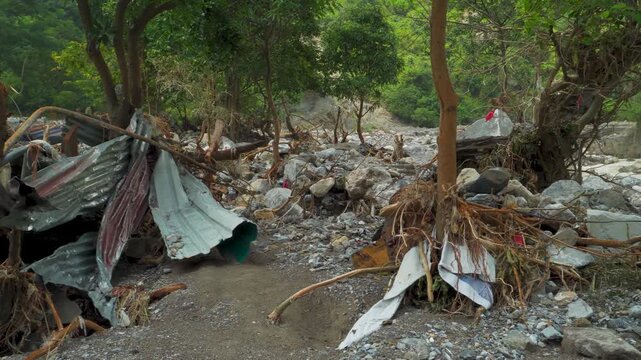 Rispana River cloudburst damages farms and homes in Rajpur Dehradun. Aftermath of floods. Scattered debris.