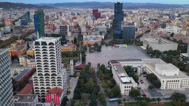 Aerial video of Tirana's Skanderbeg Square surrounded by Modern High Rises. 