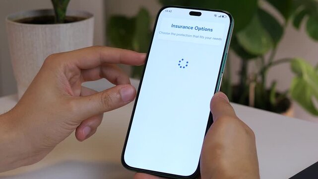 Closeup of a mans hands using a smartphone to browse an insurance marketplace, specifically finding and selecting a gadget insurance policy to review its terms and cost. This clip captures the modern