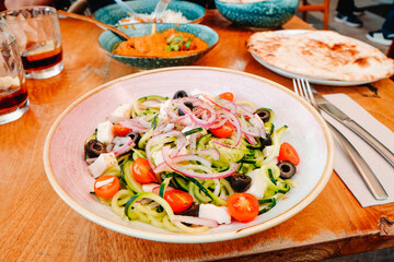a fresh cucumber salad served at a restaurant table