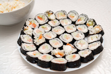 Sushi rolls arranged beautifully on a white plate for a delightful dining experience