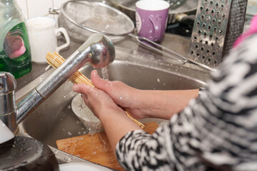 Day after the party cleaning up messy kitchen with water and hands