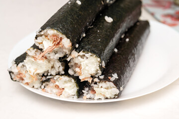 Freshly made Tuna and Philadelphia roll stacks invitingly on a bright white plate, ready for a delightful meal