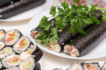 Culinary artistry presents fresh sushi rolls with vibrant greens for a delightful dining experience in Japanese tradition
