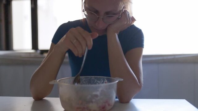 Sad woman lacking appetite for breakfast