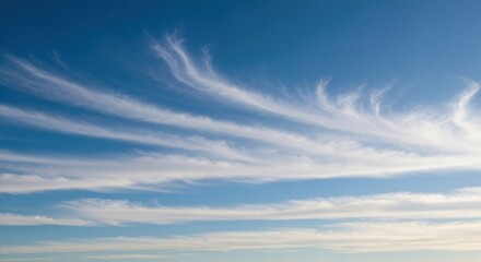 Wispy, layered clouds against a vibrant azure sky