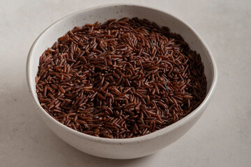 Bowl of long wholemeal red rice.