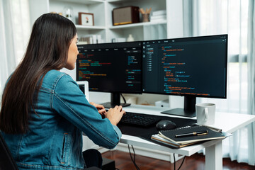 Young Asian in IT developer creating with typing online information on pc with coding program data...